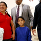 Darwin Micheal Mejia, bottom center, and his mother, Beata Mariana de Jesus Mejia-Mejia, left, are escorted to a news conference following their reunion at Baltimore-Washington International Thurgood Marshall Airport, Friday, June 22, 2018, in Linthicum, Md.